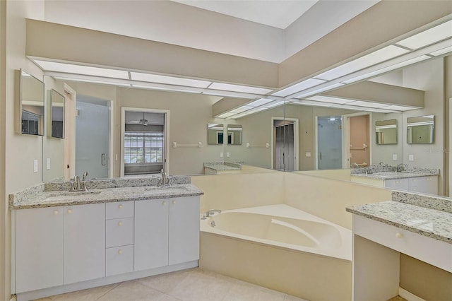 bathroom featuring vanity, ceiling fan, tile patterned flooring, and a tub