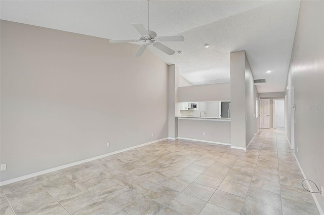 unfurnished living room featuring ceiling fan, light tile patterned flooring, a textured ceiling, and high vaulted ceiling