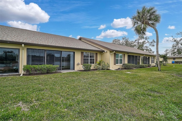 rear view of property with a yard