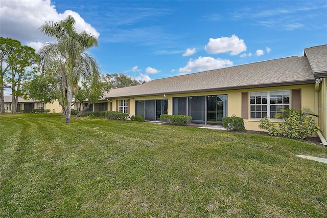 rear view of property featuring a yard