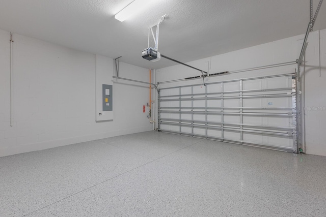 garage with electric panel and a garage door opener