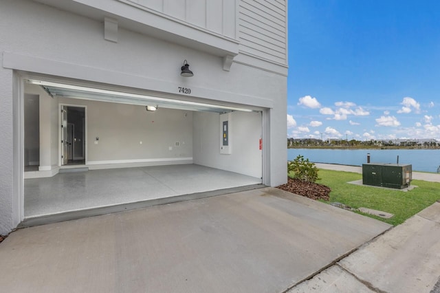 garage with a water view and a yard