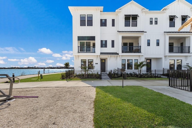 view of front of home featuring a front yard and a water view