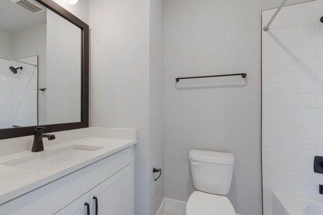 full bathroom featuring toilet, vanity, and tiled shower / bath combo