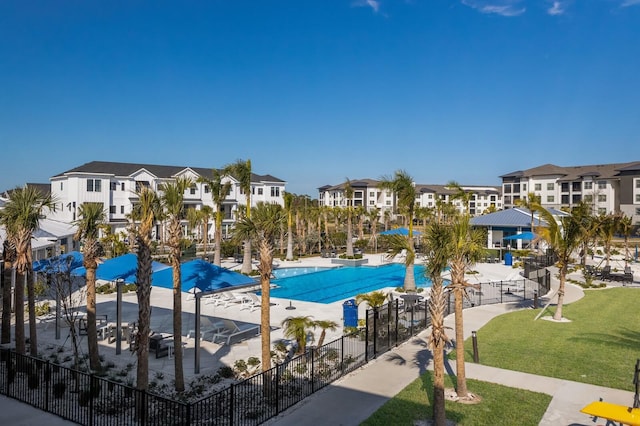 view of pool with a patio area and a lawn