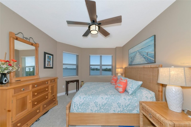 carpeted bedroom featuring ceiling fan and multiple windows