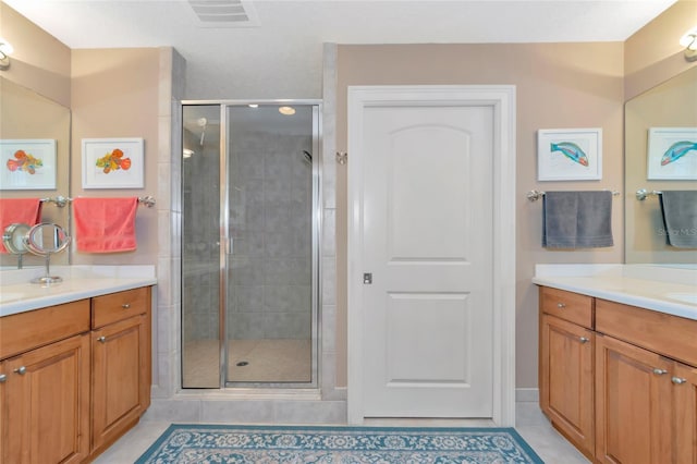 bathroom featuring tile patterned floors, vanity, and an enclosed shower