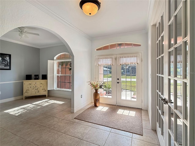 doorway to outside featuring tile patterned flooring, ceiling fan, ornamental molding, and french doors