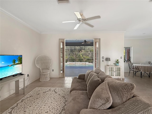 living room featuring crown molding, light tile patterned floors, and ceiling fan