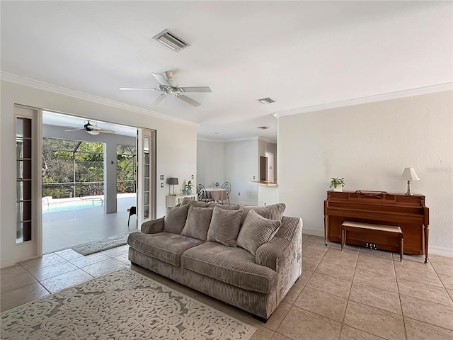 living room featuring ceiling fan, light tile patterned floors, and crown molding