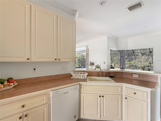 kitchen featuring dishwasher, cream cabinetry, a healthy amount of sunlight, and sink