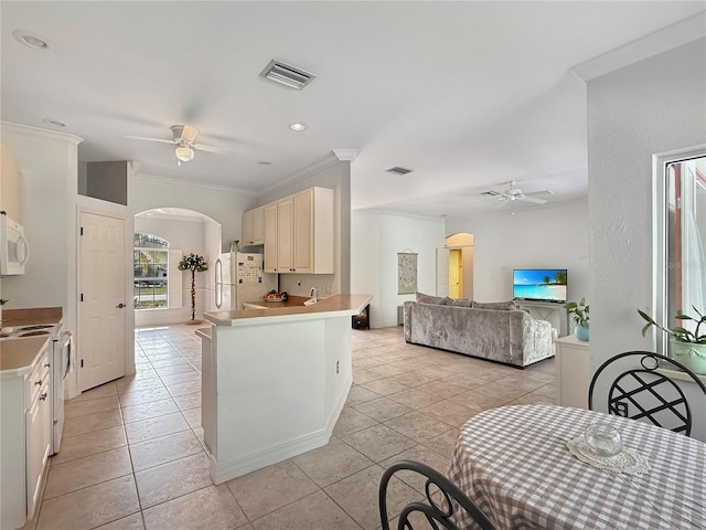 kitchen featuring ceiling fan, light tile patterned floors, white appliances, and ornamental molding