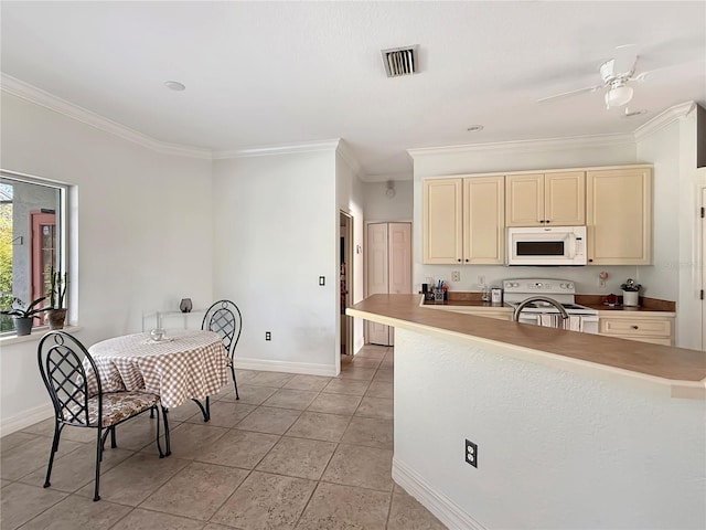 kitchen featuring white appliances, cream cabinets, crown molding, ceiling fan, and light tile patterned flooring