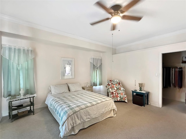 carpeted bedroom with ceiling fan, a closet, and ornamental molding