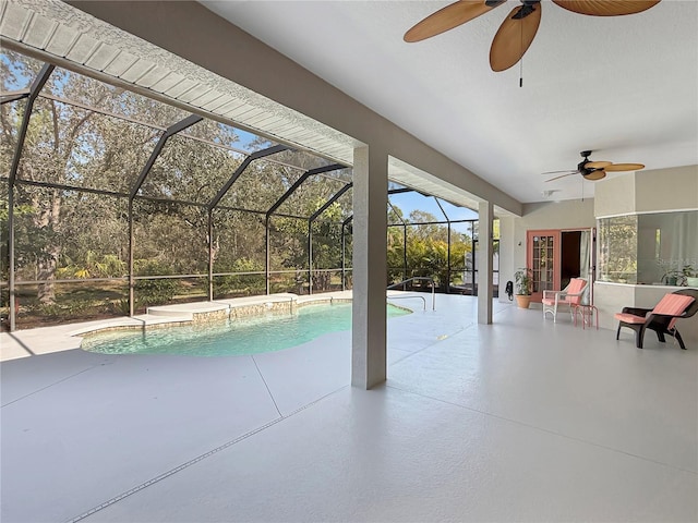 view of swimming pool featuring a lanai, ceiling fan, and a patio area