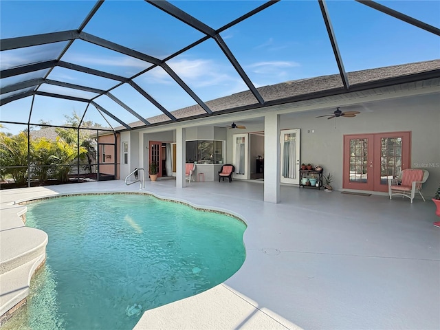 view of pool with ceiling fan, a patio, glass enclosure, and french doors