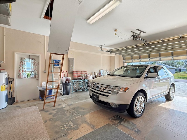 garage featuring a garage door opener, electric water heater, and electric panel