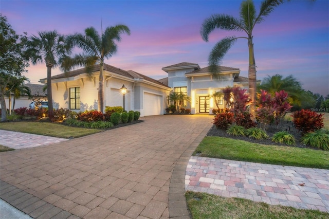 view of front of house with a yard and a garage