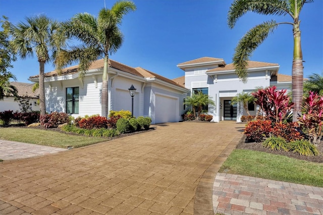 view of front of property featuring a garage and french doors