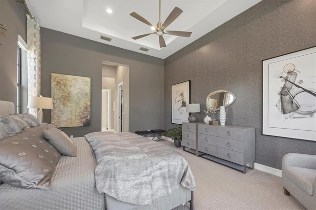 bedroom with ceiling fan and light carpet