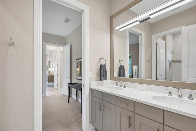 bathroom featuring walk in shower and vanity