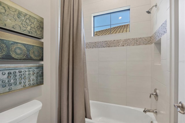 bathroom featuring toilet and shower / bath combo