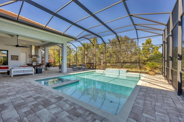 view of swimming pool featuring a lanai, ceiling fan, and a patio area