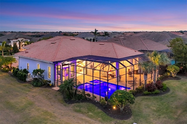 exterior space featuring a lanai, a yard, and a patio area