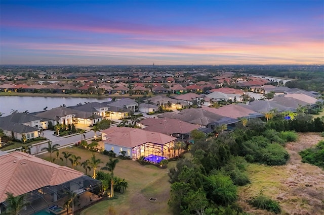 aerial view at dusk with a water view