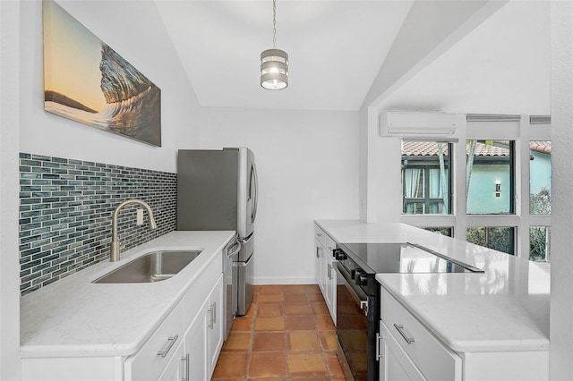 kitchen with pendant lighting, tasteful backsplash, black electric range oven, white cabinetry, and a sink