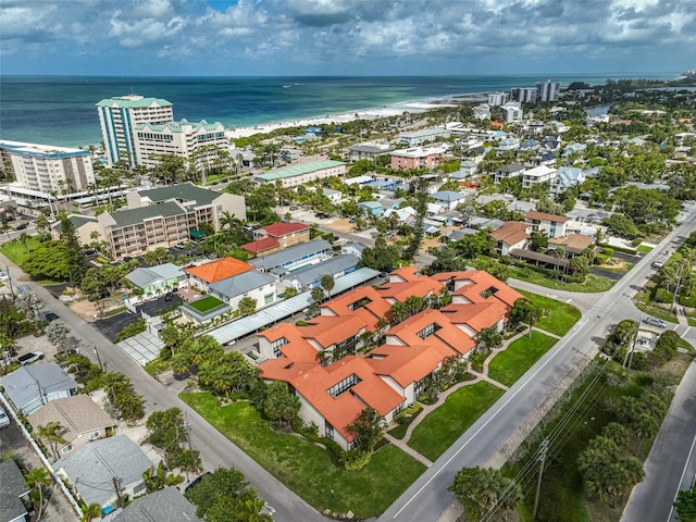 birds eye view of property featuring a beach view and a water view