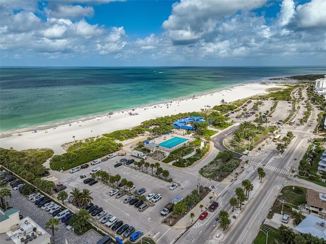 drone / aerial view with a beach view and a water view