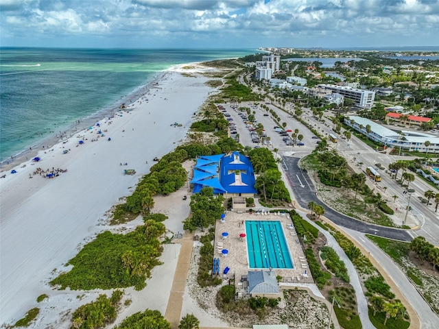 bird's eye view with a water view and a beach view