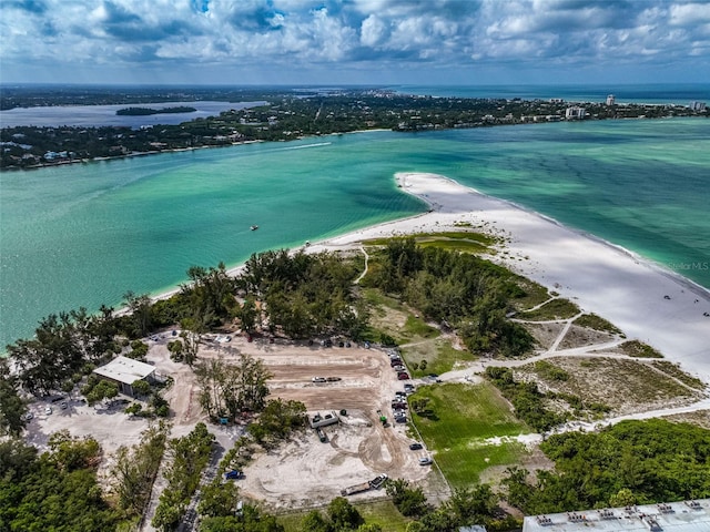 birds eye view of property featuring a water view and a beach view