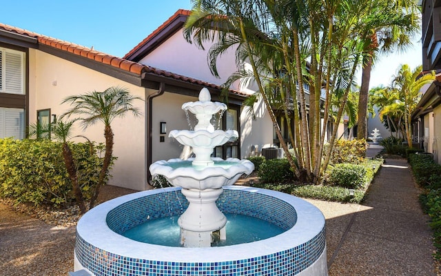 800 S Blvd Of Presidents Unit 12, Sarasota, FL 34236 - exterior view of stucco siding, a downspout, a tiled roof, and gutters