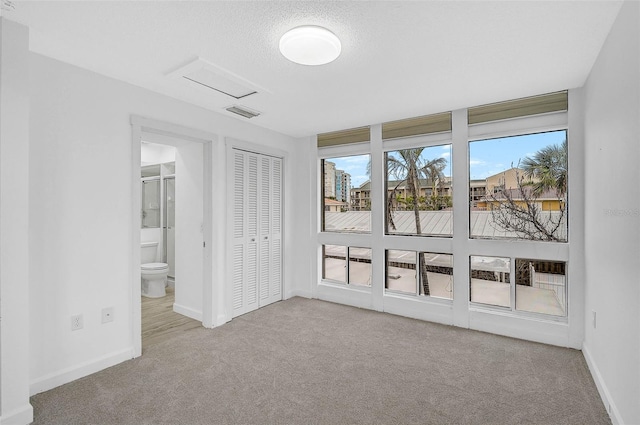 800 S Blvd Of Presidents Unit 12, Sarasota, FL 34236 - unfurnished bedroom with carpet flooring, ensuite bathroom, and a closet