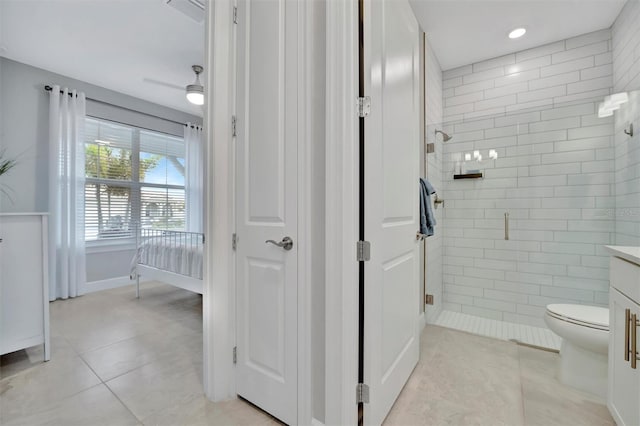 bathroom featuring toilet, an enclosed shower, tile patterned floors, and vanity