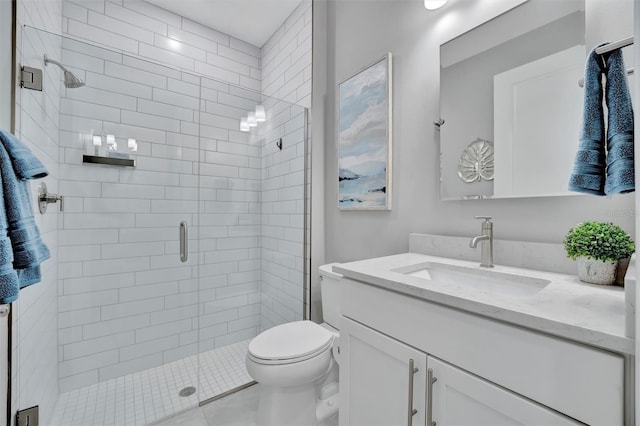 bathroom featuring vanity, toilet, and walk in shower