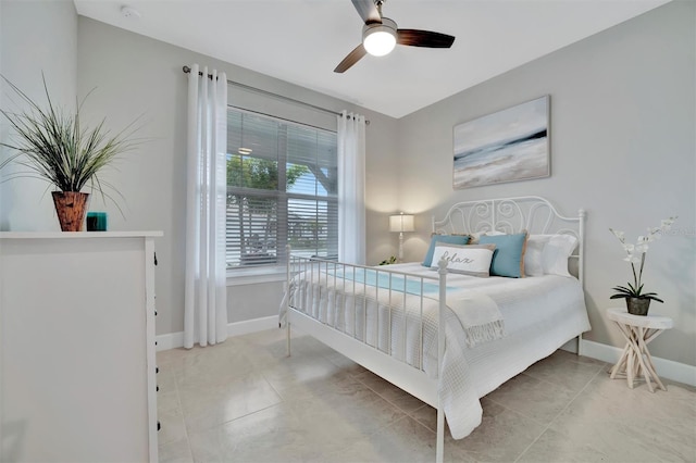 tiled bedroom featuring ceiling fan