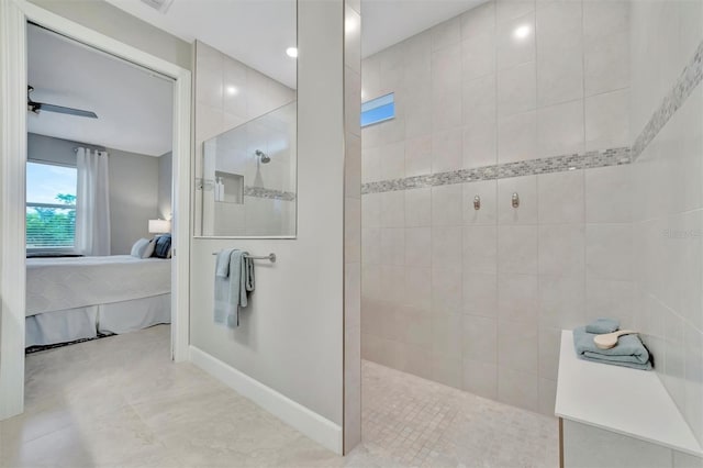 bathroom with a tile shower and ceiling fan