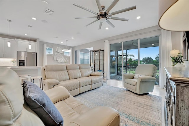 living room with ceiling fan and light tile patterned floors