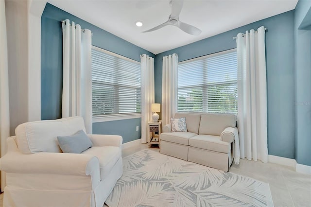 living room with ceiling fan and light tile patterned flooring