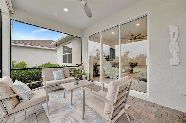 sunroom featuring ceiling fan