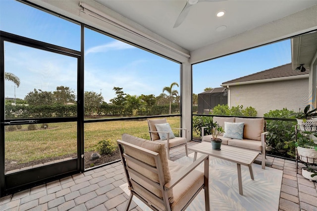 sunroom with a healthy amount of sunlight and ceiling fan