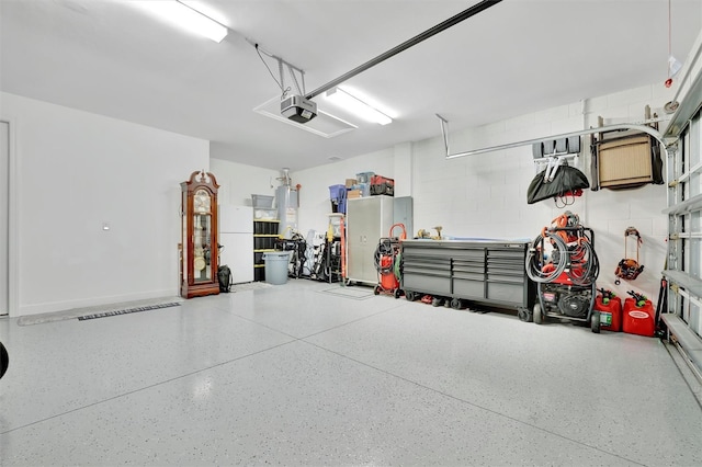 garage featuring a garage door opener, water heater, and white fridge