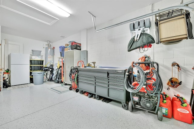 garage with white refrigerator and gas water heater