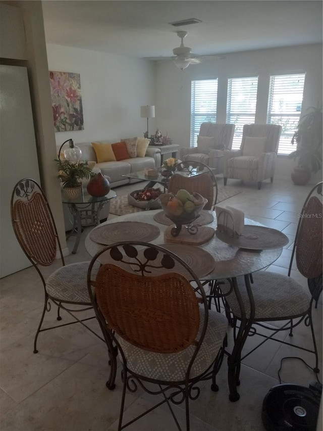 dining room featuring light tile patterned flooring and ceiling fan