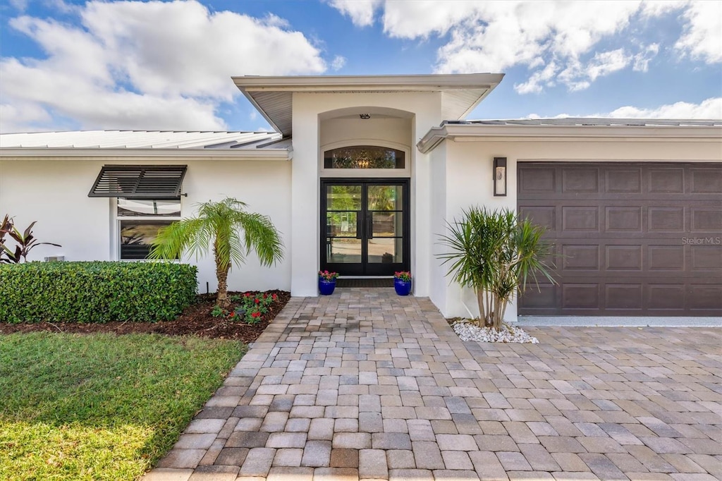 view of exterior entry with a garage