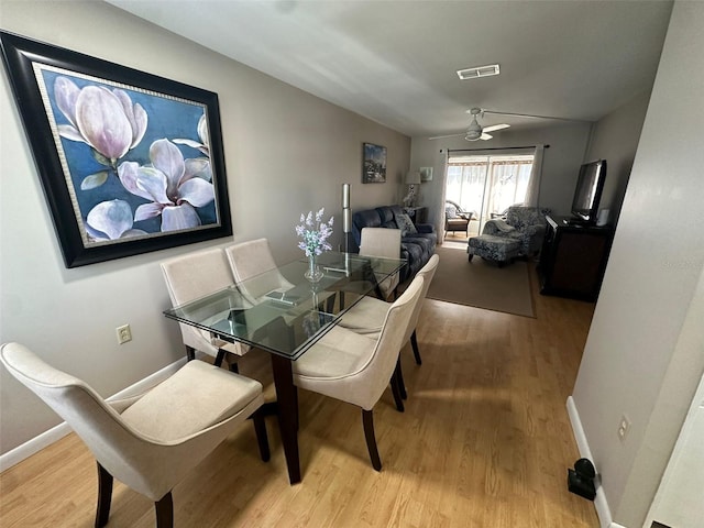 dining area with ceiling fan and light wood-type flooring