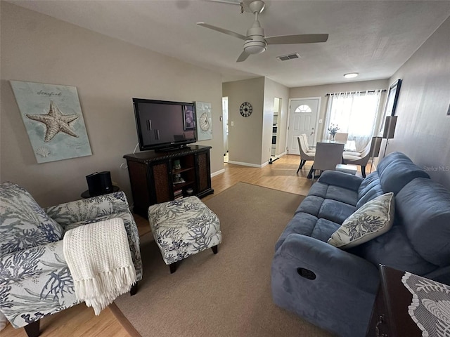 living room featuring ceiling fan and light wood-type flooring